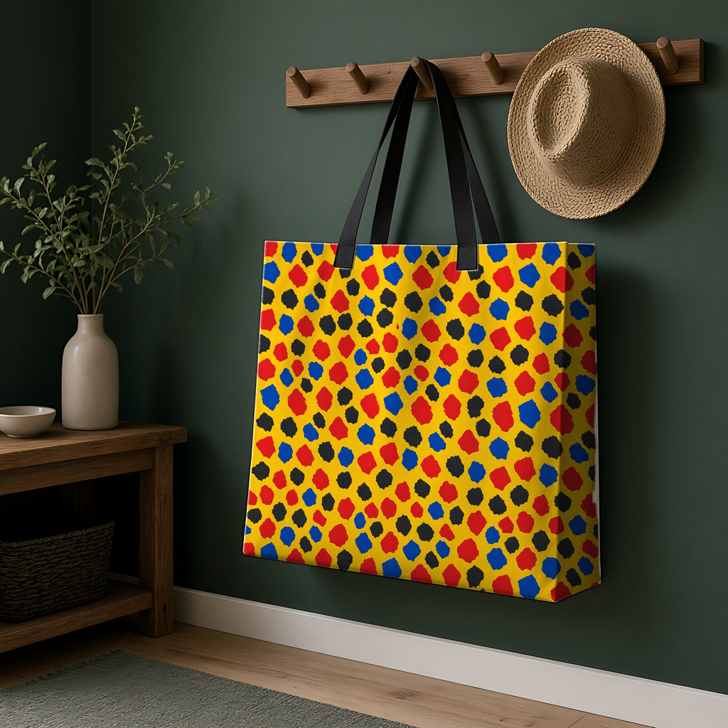 Confetti Scraps Yellow Weekender Tote Bag hanging on a peg rail in a green hallway