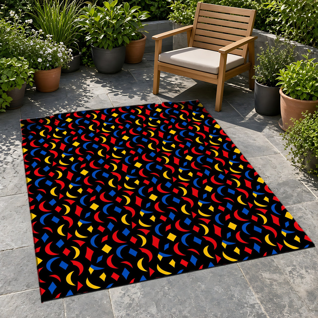 Crescent Scatter Outdoor Rug on a stone patio with potted plants