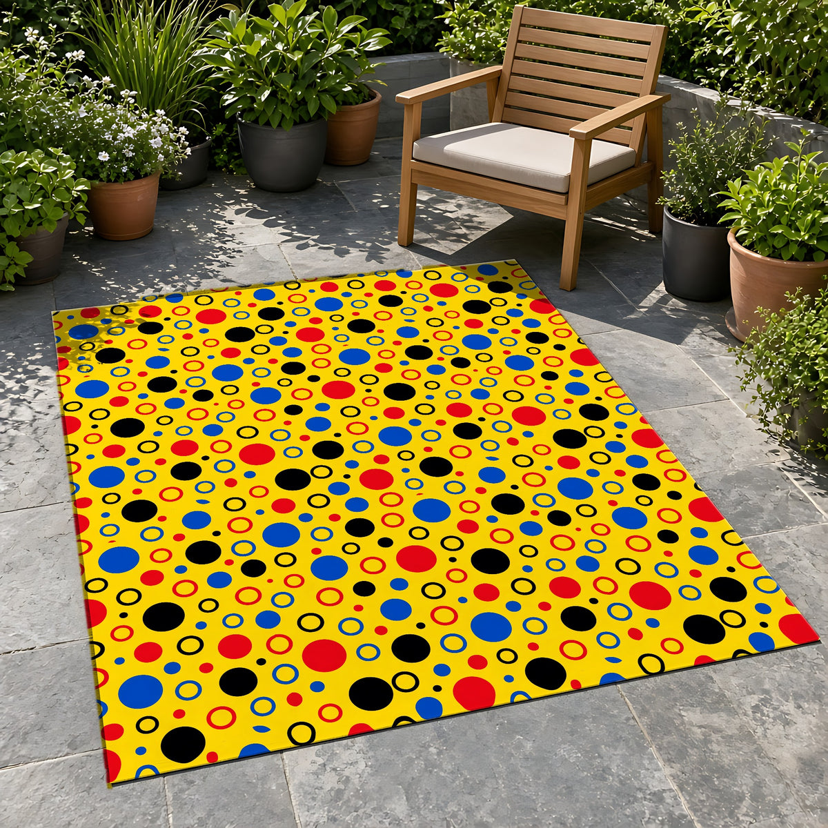 Bubble Outlines Outdoor Rug on a stone patio with potted plants