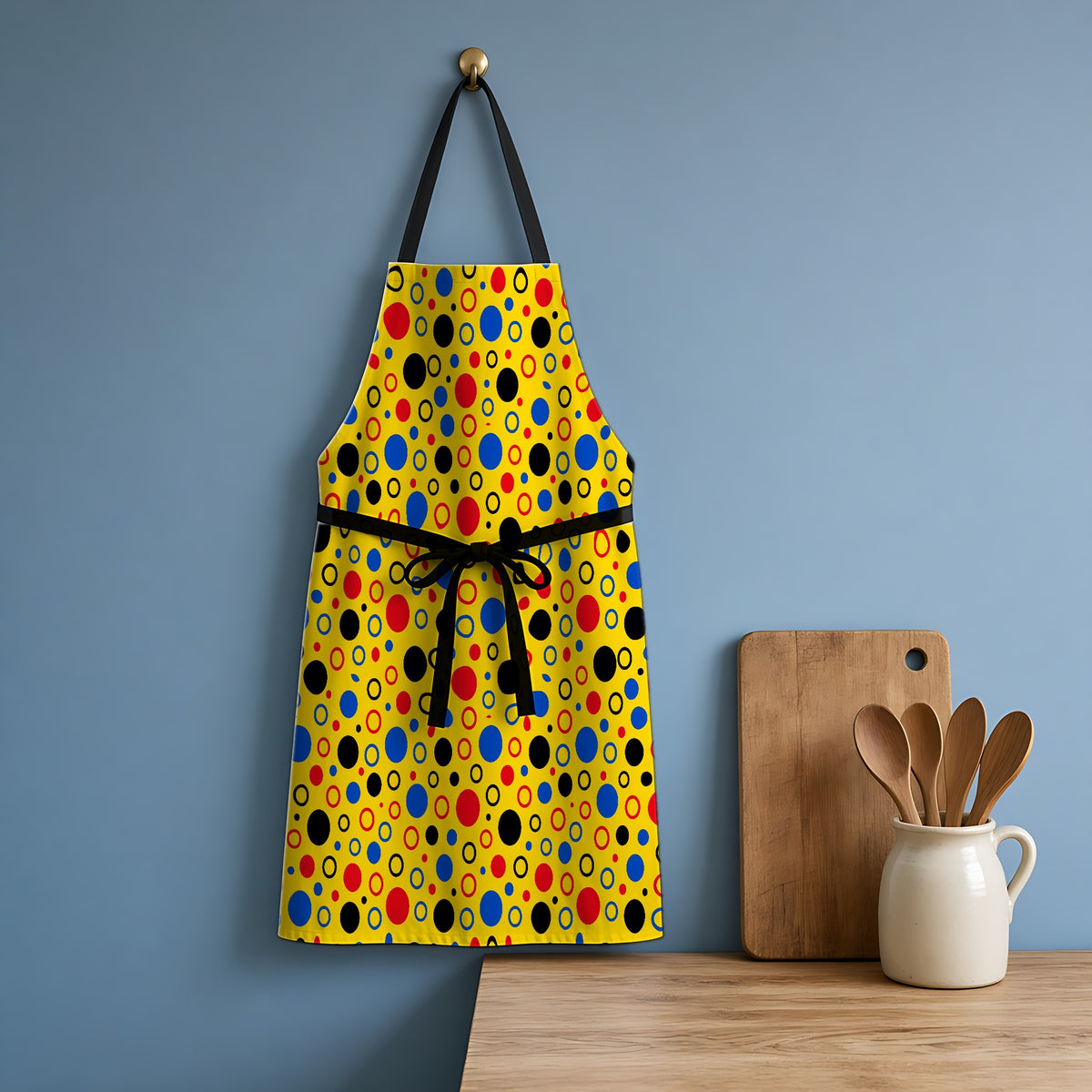 Bubble Outlines Apron hanging in a blue kitchen