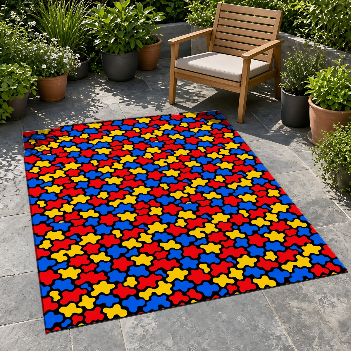 Blob Black Outdoor Rug on a stone patio with potted plants