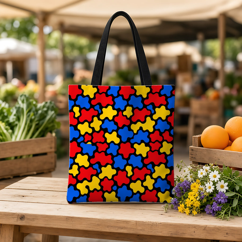 Blob Black Weekender Tote Bag on a wooden bench at a farmers market