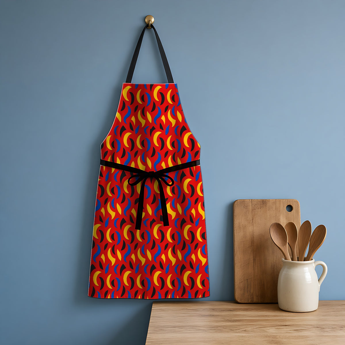 Swoosh Cutouts Apron hanging in a blue kitchen