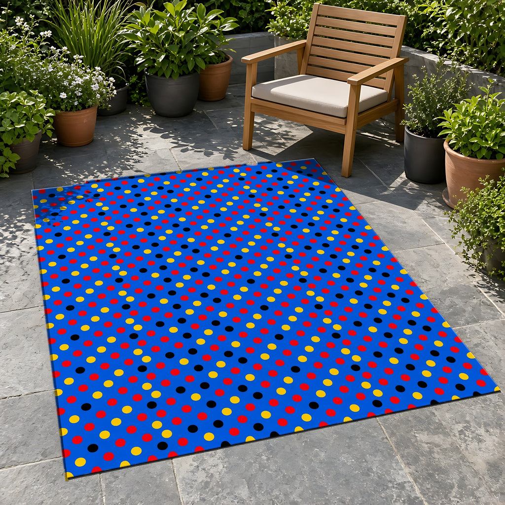 Dot Scatter Blue Outdoor Rug on a stone patio with potted plants