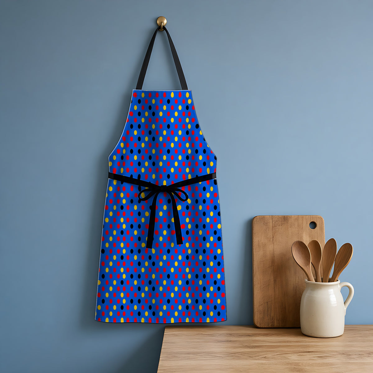 Dot Scatter Blue Apron hanging in a blue kitchen