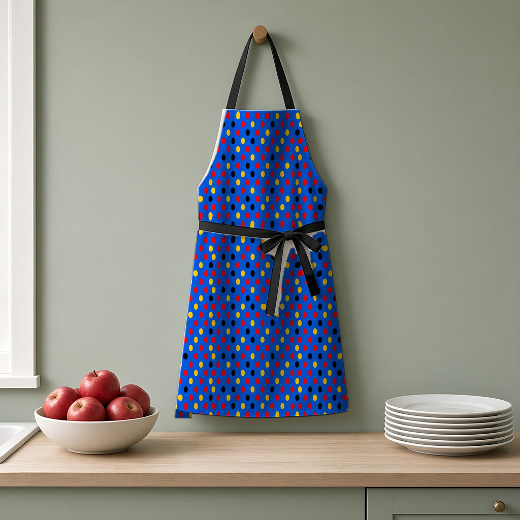 Dot Scatter Blue Apron hanging on a sage-green kitchen wall