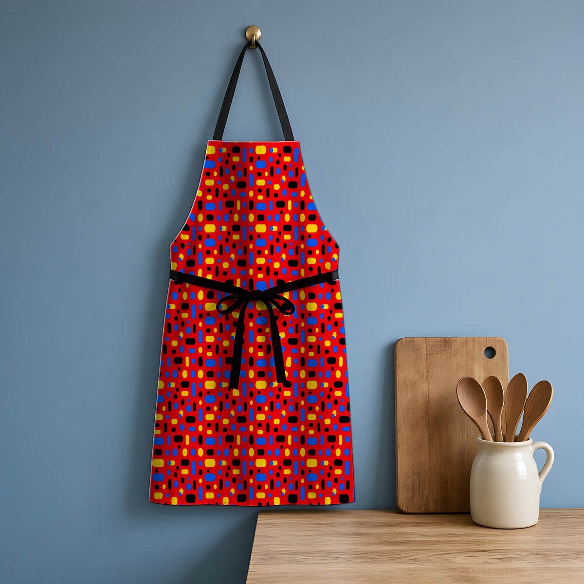 Confetti Dash Red Apron hanging in a blue kitchen