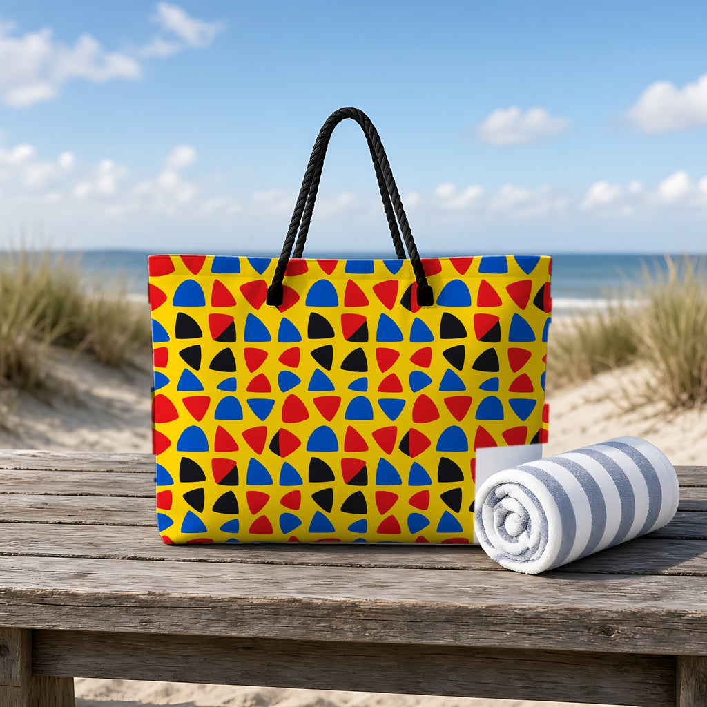 Cut-Out Arcs Yellow Weekender Tote Bag on a rustic table by the beach