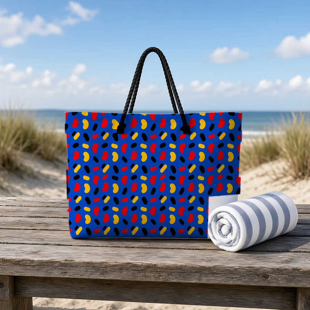 Bean Scatter Blue Weekender Tote Bag on a rustic table by the beach