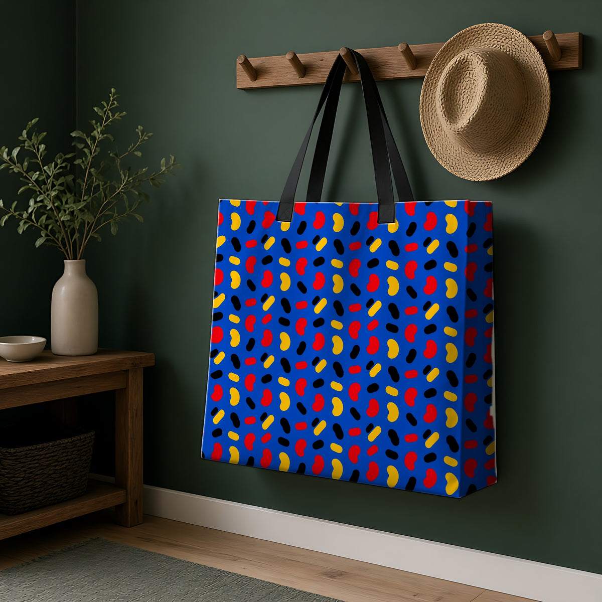 Bean Scatter Blue Weekender Tote Bag hanging on a peg rail in a green hallway
