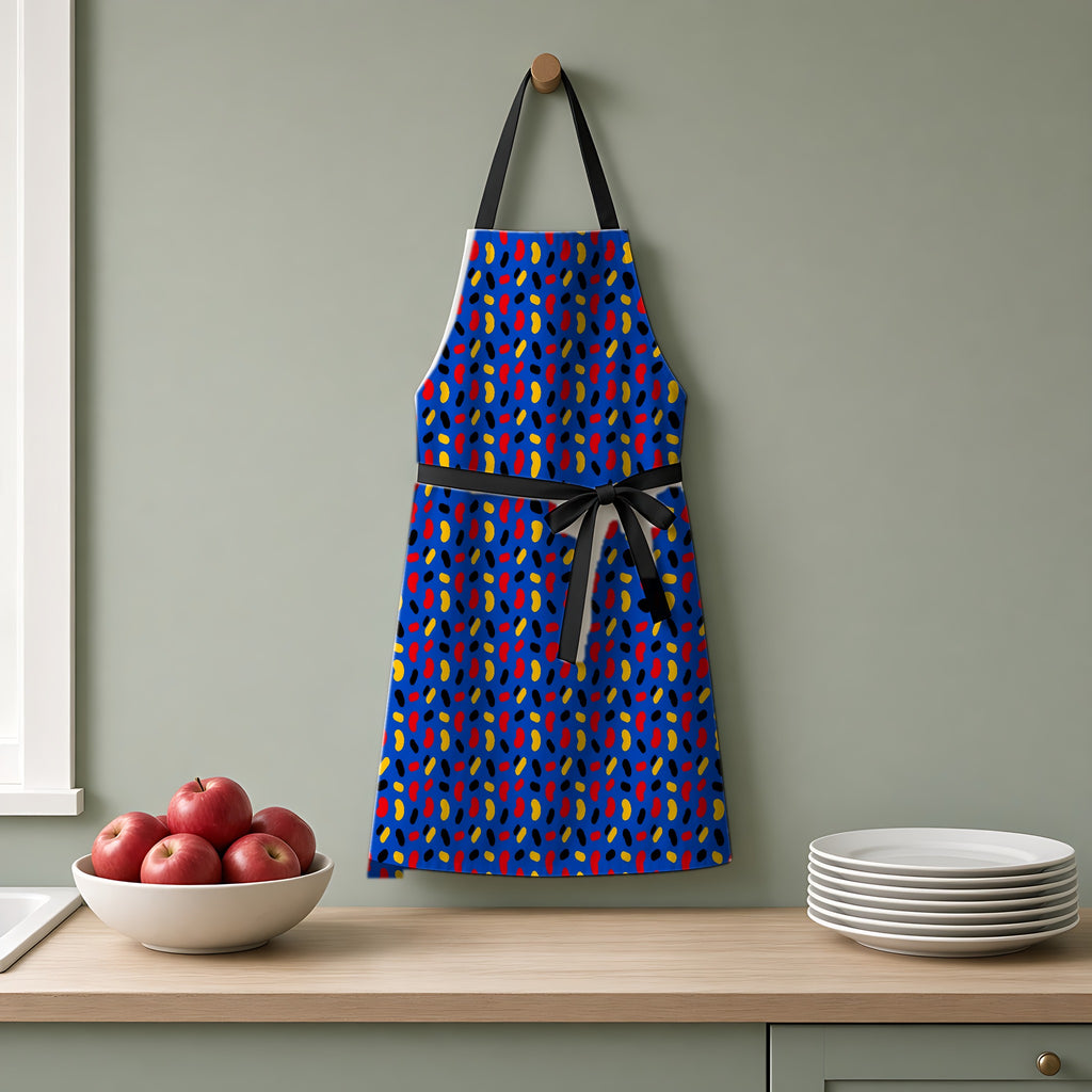 Bean Scatter Blue Apron hanging on a sage-green kitchen wall
