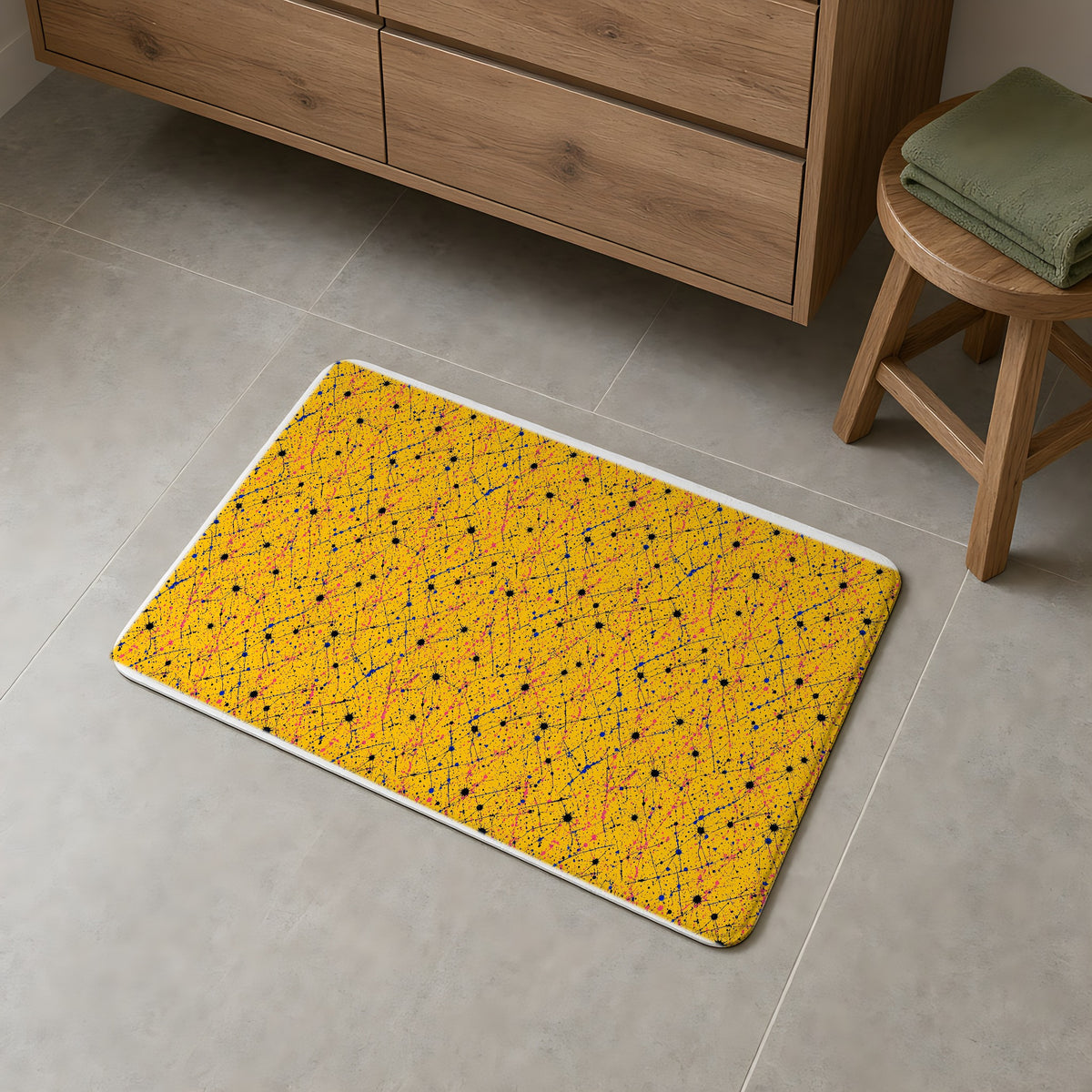 Drip Trails Bath Mat on a grey tiled bathroom floor