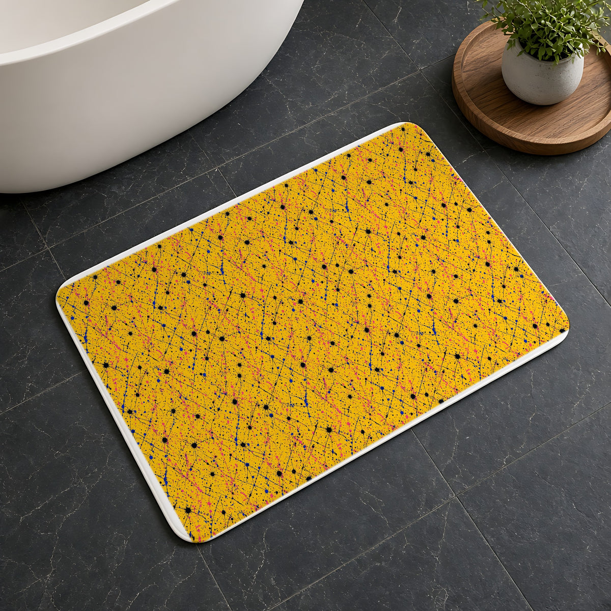 Drip Trails Bath Mat on a dark slate floor beside a bath