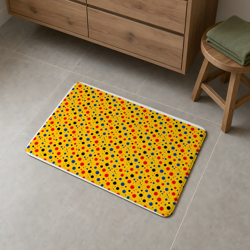 Blot Burst Bath Mat on a grey tiled bathroom floor