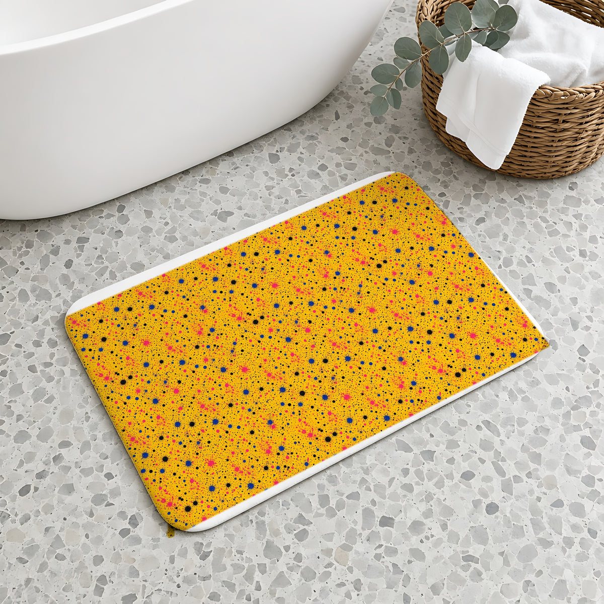 Pink Spray Field Bath Mat on a terrazzo floor beside a freestanding bath