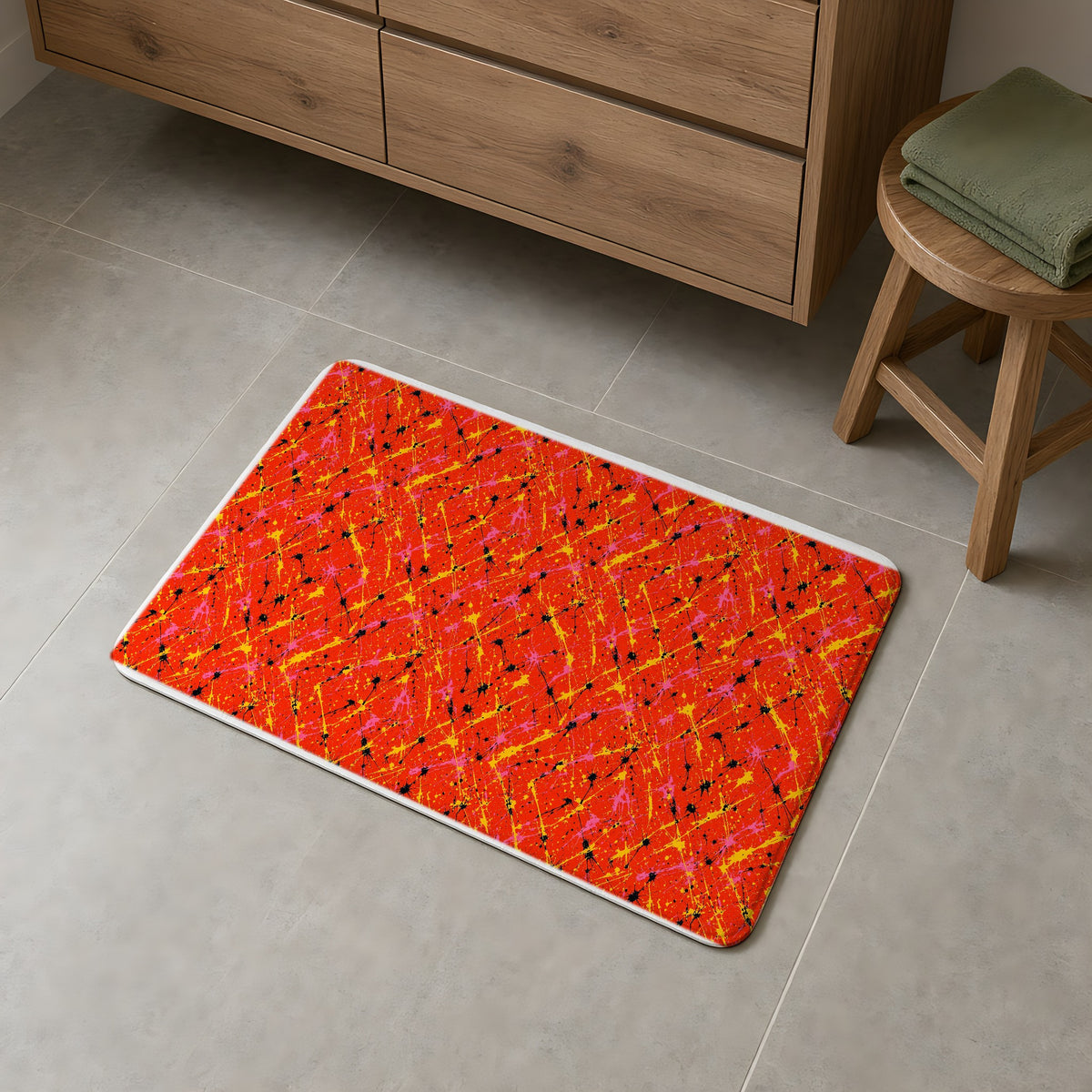 Vermilion Riot Bath Mat on a grey tiled bathroom floor