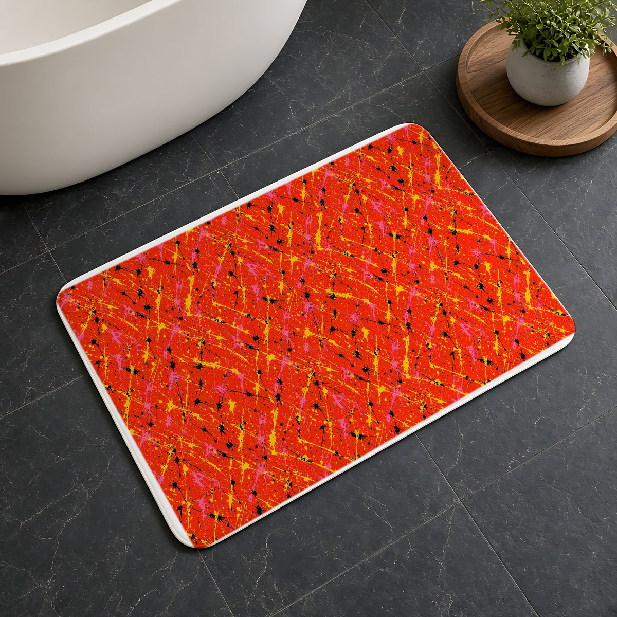 Vermilion Riot Bath Mat on a dark slate floor beside a bath