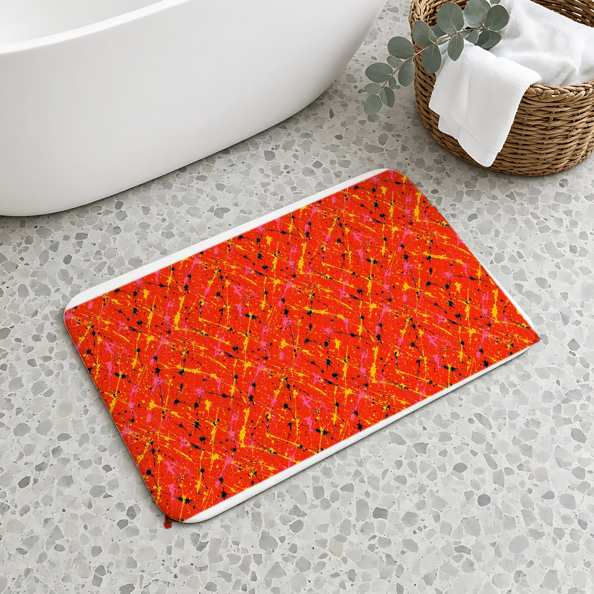Vermilion Riot Bath Mat on a terrazzo floor beside a freestanding bath