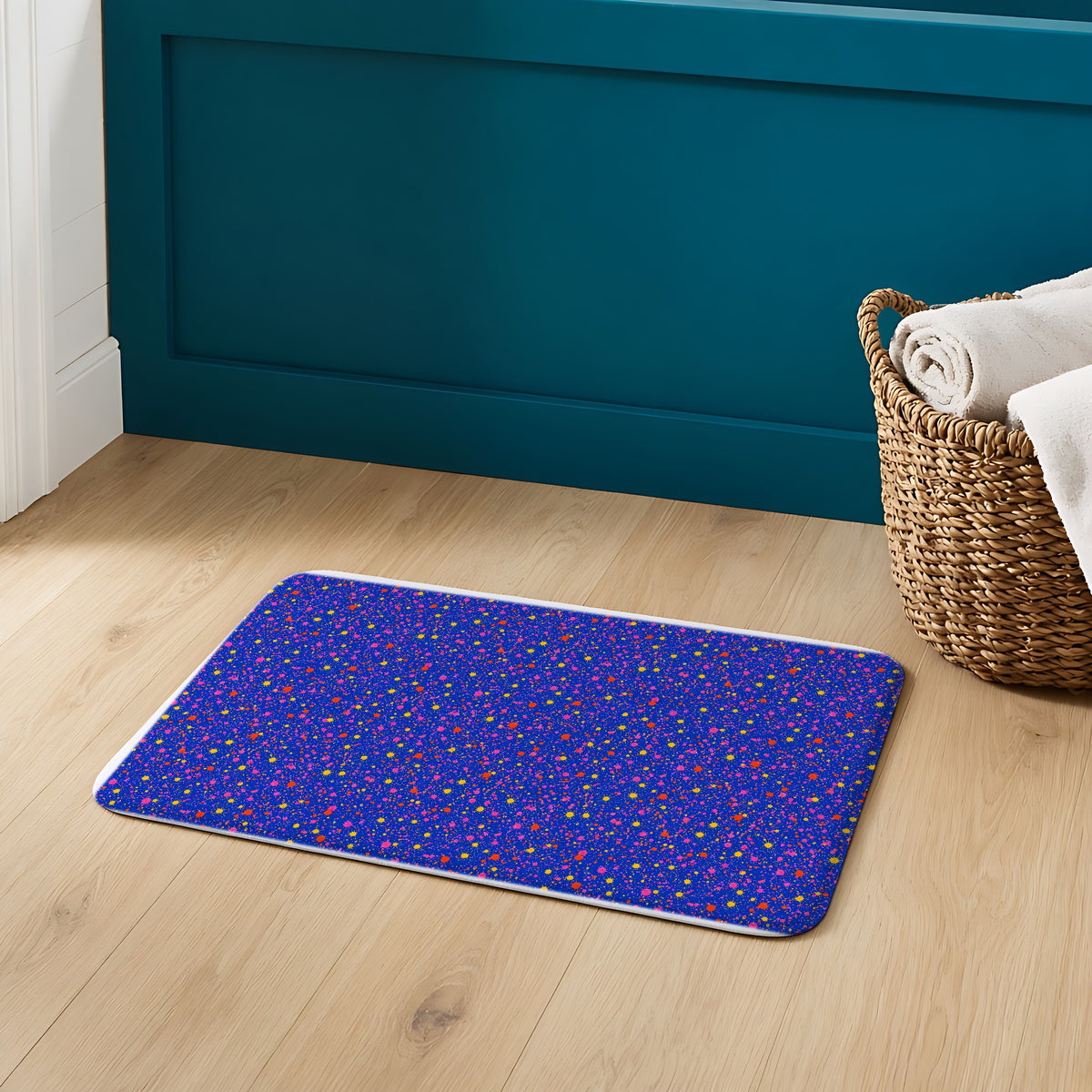 Ultramarine Spatter Bath Mat on an oak floor in a teal bathroom