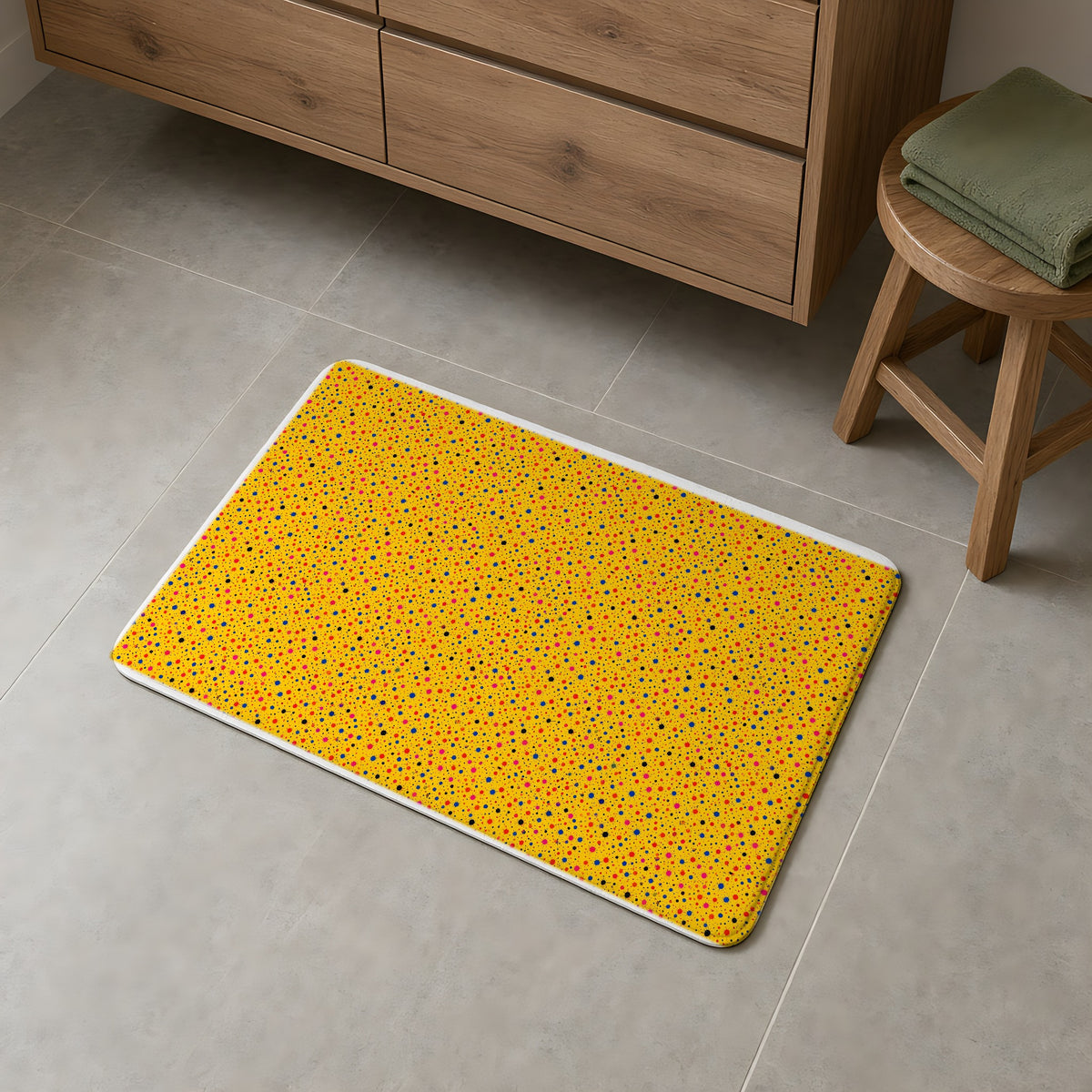 Confetti Spatter Bath Mat on a grey tiled bathroom floor