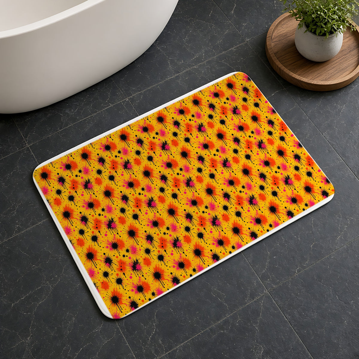Black Ink Burst Bath Mat on a dark slate floor beside a bath
