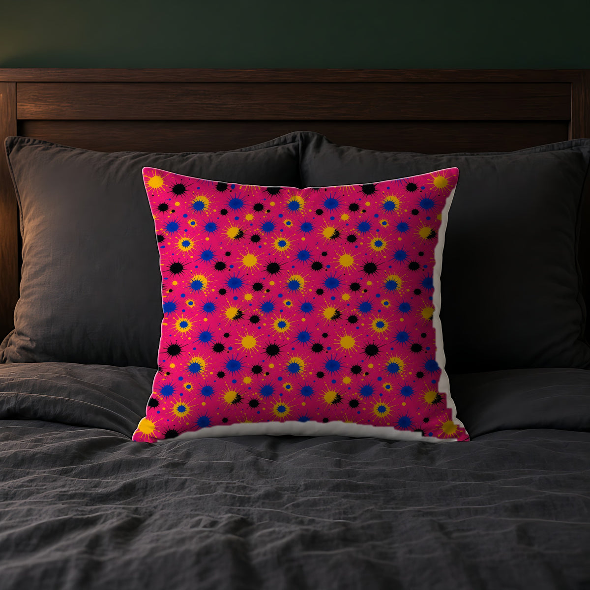 Pink Ground Splash Faux Suede Cushion on a bed with charcoal bedding