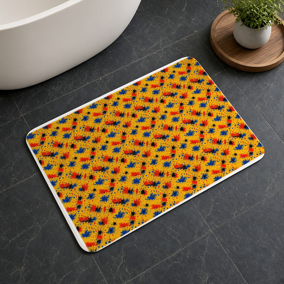 Dragged Smears Bath Mat on a dark slate floor beside a bath