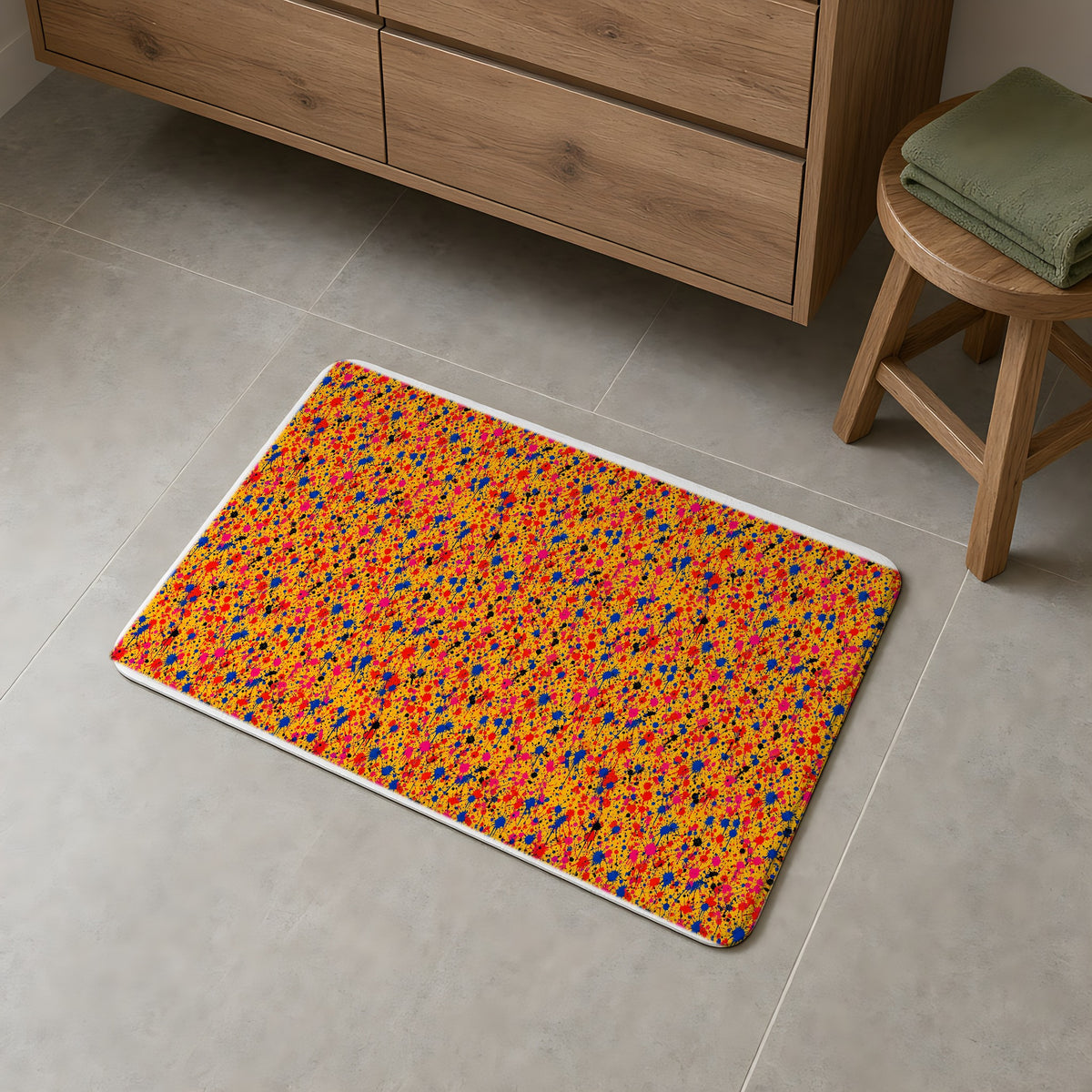 Layered Drip Spray Bath Mat on a grey tiled bathroom floor