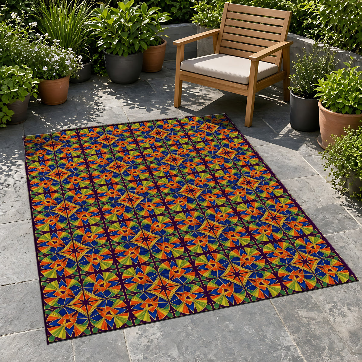 Kaleido Fan Quatrefoil Outdoor Rug on a stone patio with potted plants