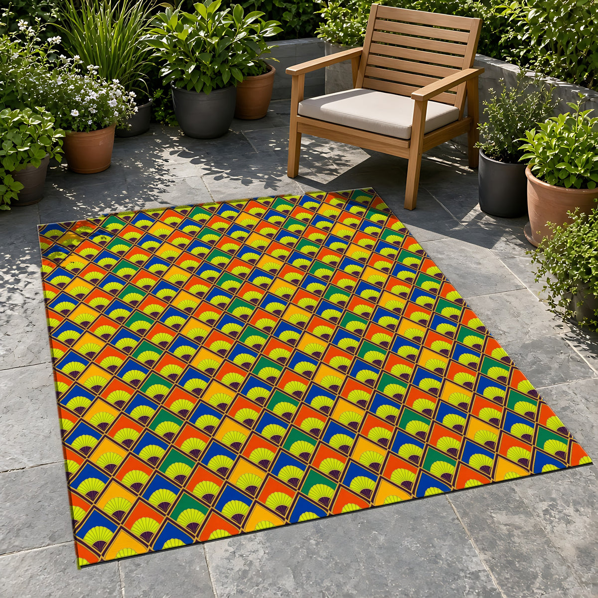 Fanfare Harlequin Outdoor Rug on a stone patio with potted plants