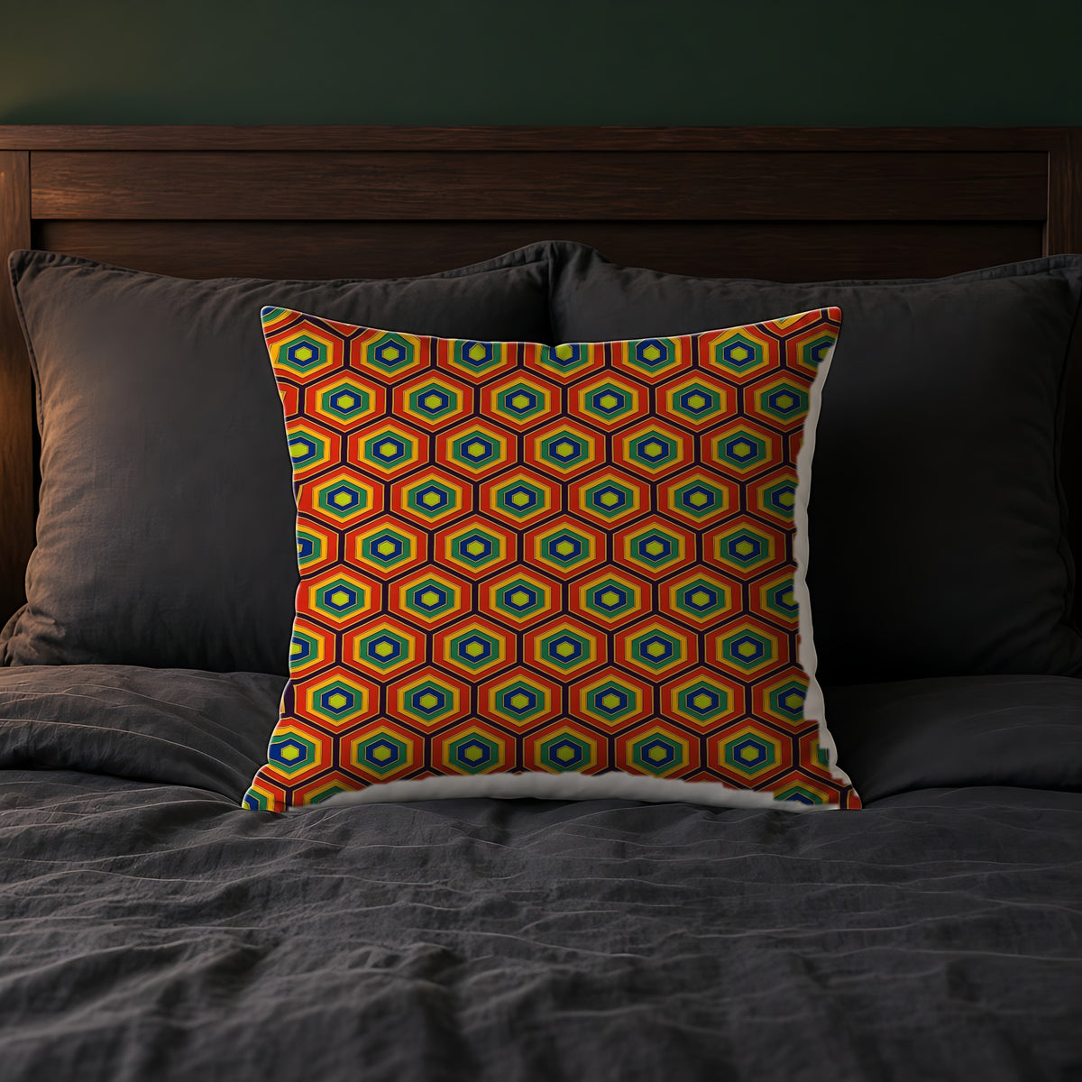 Hexagon Enamel Nest Faux Suede Cushion on a bed with charcoal bedding