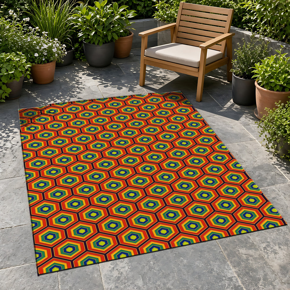 Hexagon Enamel Nest Outdoor Rug on a stone patio with potted plants