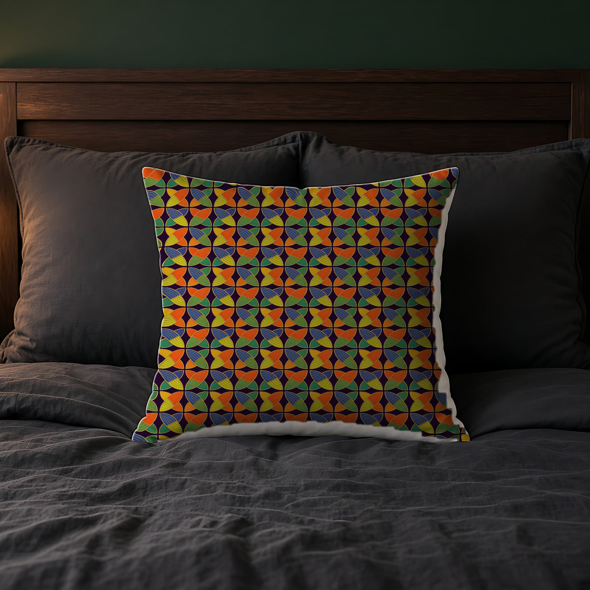 Woven Petal Quatrefoil Faux Suede Cushion on a bed with charcoal bedding
