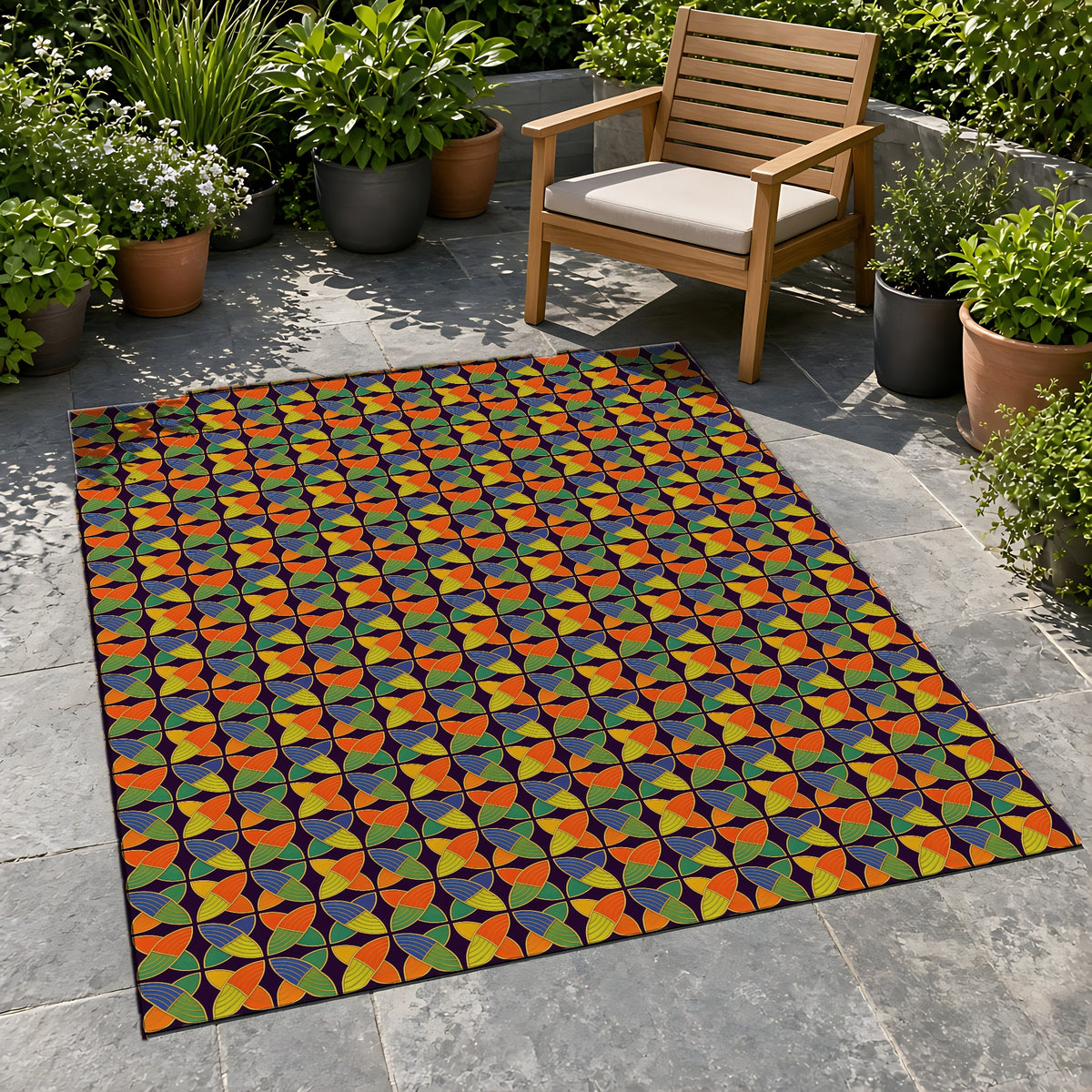 Woven Petal Quatrefoil Outdoor Rug on a stone patio with potted plants