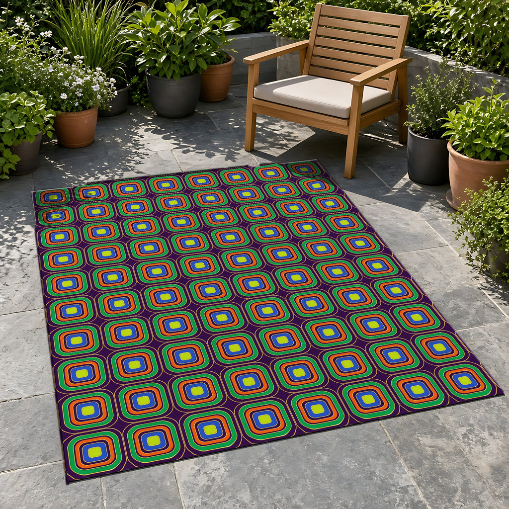Op-Deco Nested Squares Outdoor Rug on a stone patio with potted plants