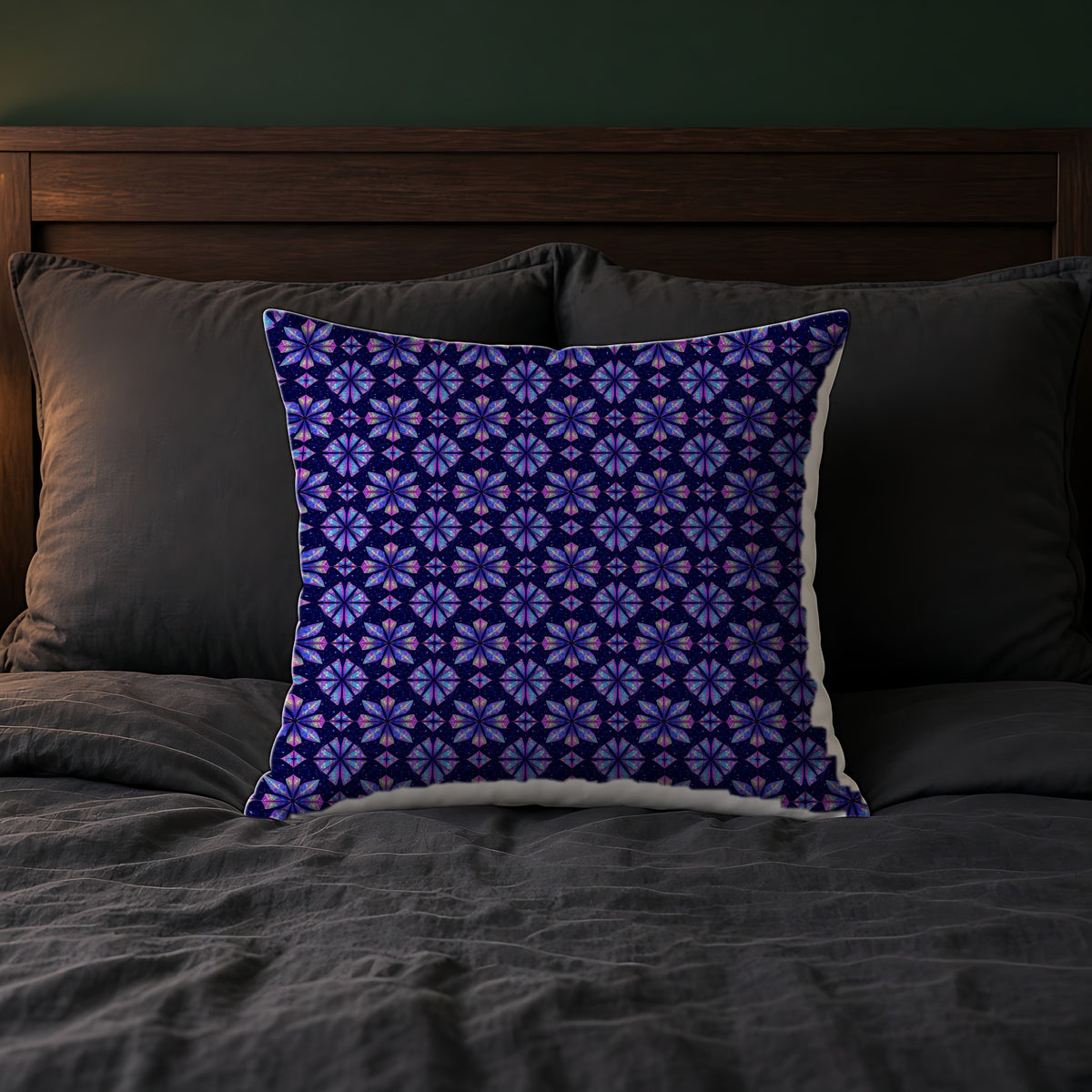 Crystal Bloom Kaleidoscope Faux Suede Cushion on a bed with charcoal bedding