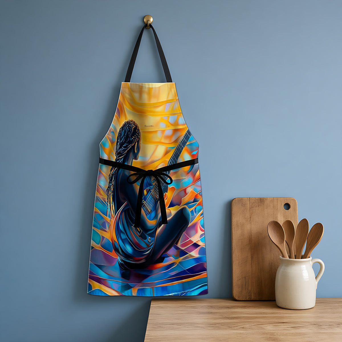 Guitar Dreamer Apron hanging in a blue kitchen