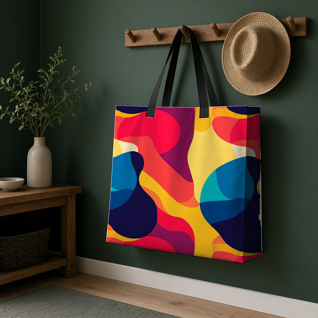 Bold Blob Camo Weekender Tote Bag hanging on a peg rail in a green hallway