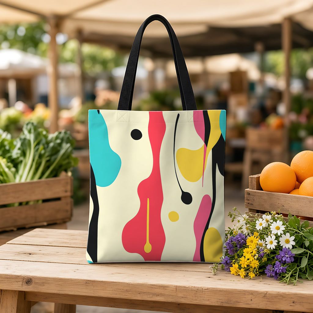 Cut-Out Blobs Weekender Tote Bag on a wooden bench at a farmers market