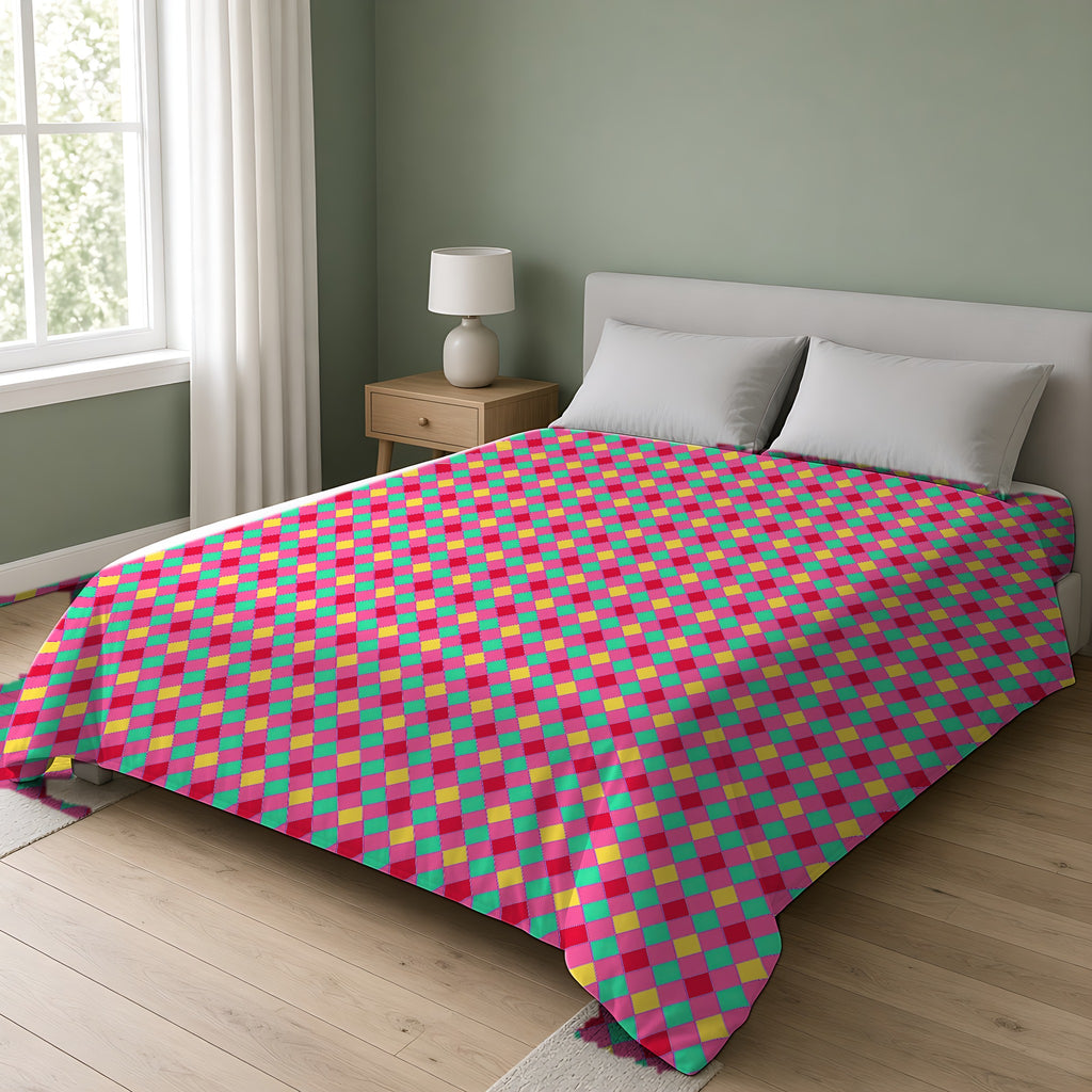 Jewel Harlequin Check Cotton Duvet Cover on a double bed in a bright sage-green bedroom