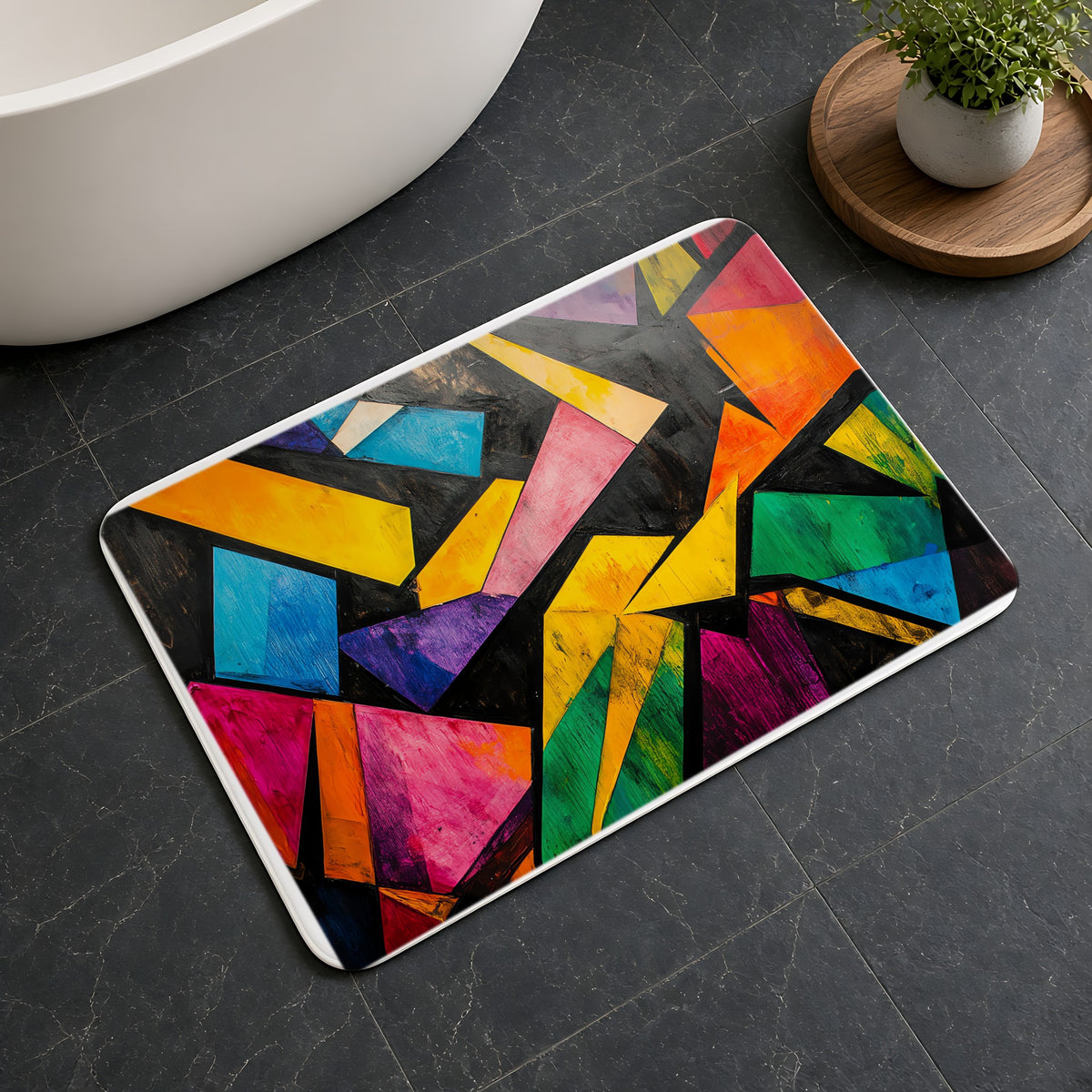 Shattered Prism Geometry Bath Mat on a dark slate floor beside a bath