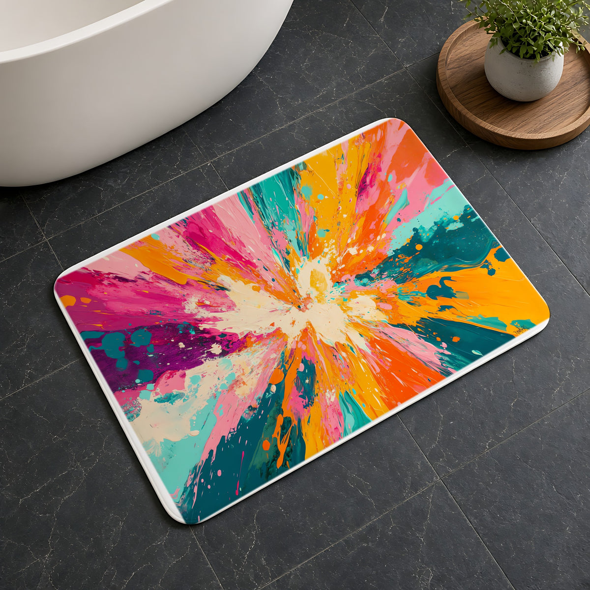 Sunburst Splash Bath Mat on a dark slate floor beside a bath