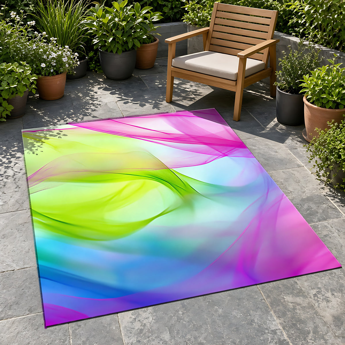 Silk Smoke Waves Outdoor Rug on a stone patio with potted plants