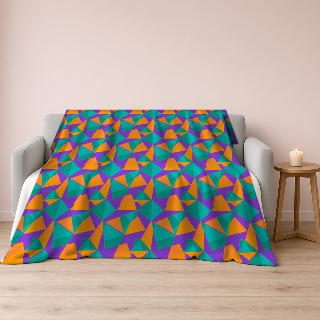 Faceted Gold Panels Sherpa Fleece Blanket draped over a grey sofa