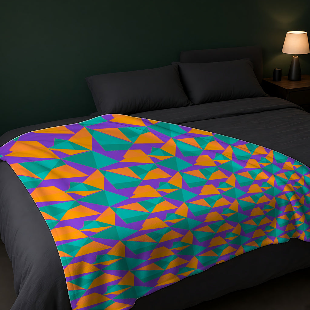 Faceted Gold Panels Sherpa Fleece Blanket across the foot of a dark bed