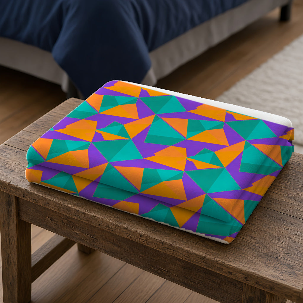 Faceted Gold Panels Sherpa Fleece Blanket folded on a wooden bench