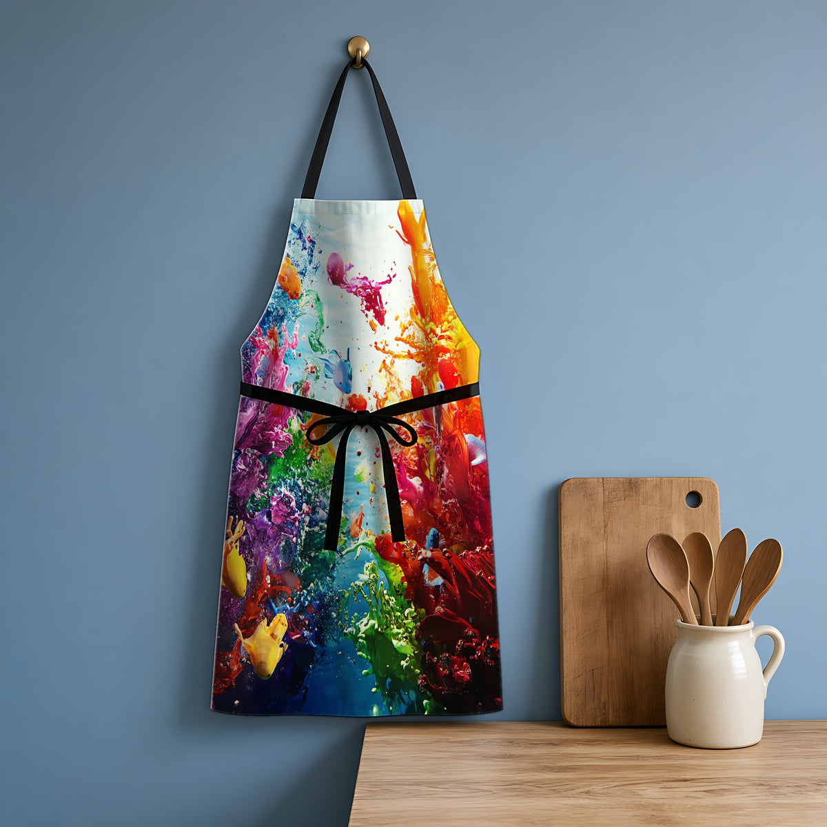 Coral Reef Splash Apron hanging in a blue kitchen