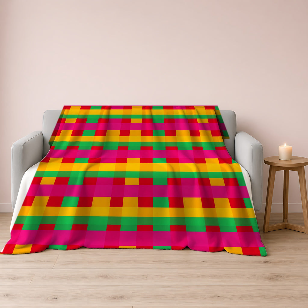Grand Jewel Plaid Sherpa Fleece Blanket draped over a grey sofa
