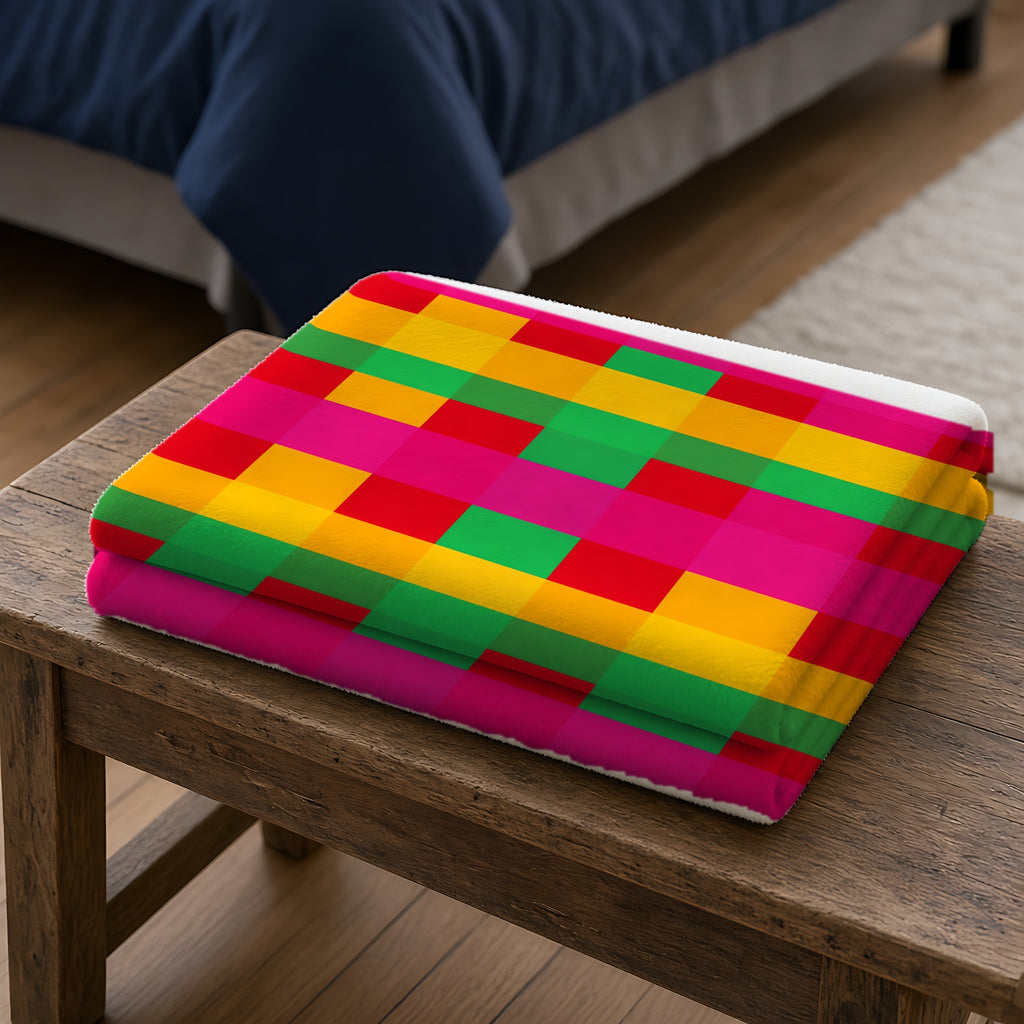 Grand Jewel Plaid Sherpa Fleece Blanket folded on a wooden bench