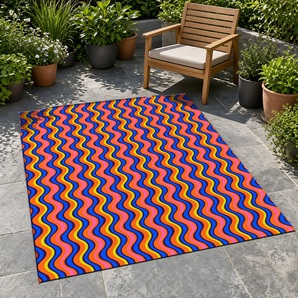 Warped Circus Stripes Outdoor Rug on a stone patio with potted plants